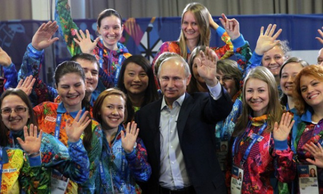Putin is rarely the best dressed in the room. In this picture, he poses surrounded by volunteers for the Sochi 2014 Olympic Games.